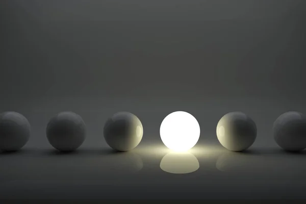 En illuminater boll bland grå bollar i rad konceptet. — Stockfoto