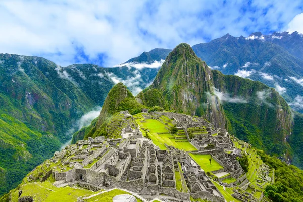 Overview of Machu Picchu, agriculture terraces and Wayna Picchu peak in the background Royalty Free Stock Images