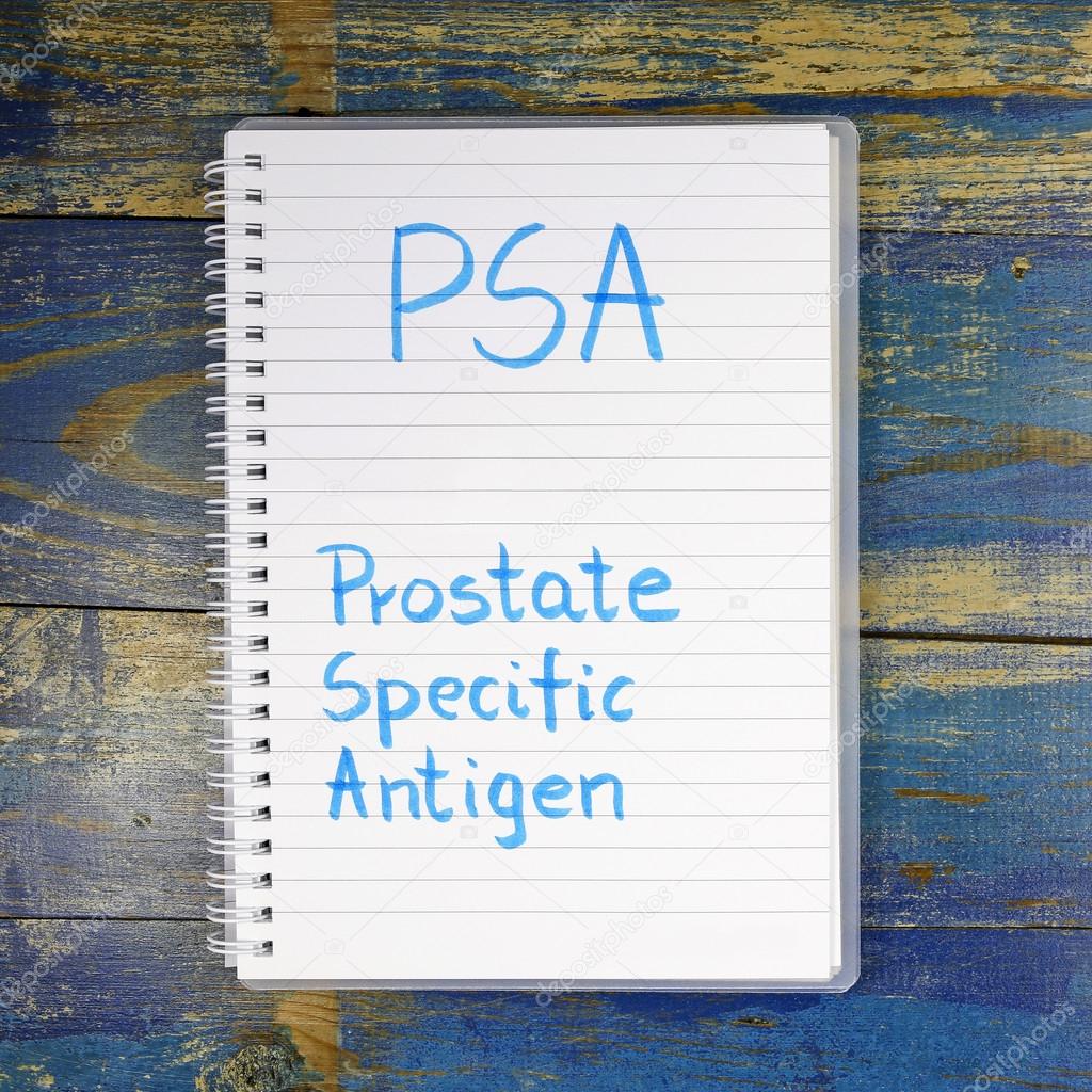 PSA- Prostate-specific antigen written in notebook on wooden background