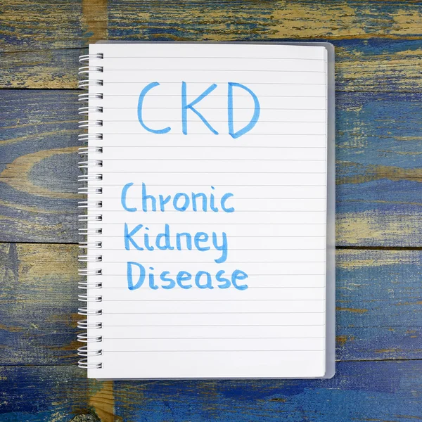 CKD- Chronic Kidney Disease written in notebook on wooden background