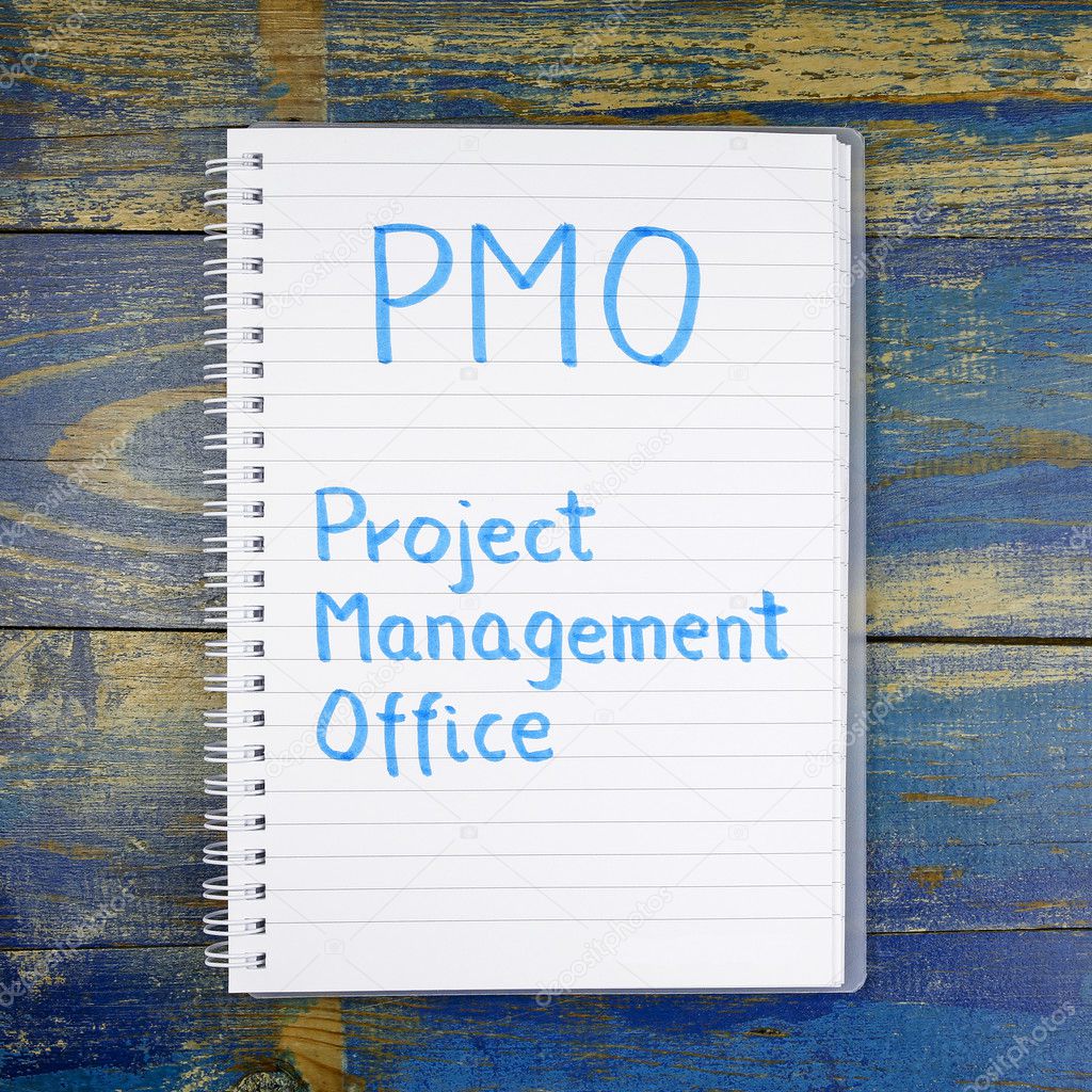 PMO- Project Management Office written in notebook on wooden background