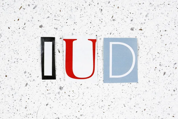 IUD (Intra Uterine Device) acronym on handmade paper texture — ストック写真