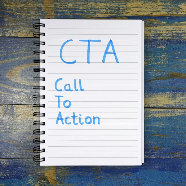 CTA- Call To Action written in notebook on wooden background