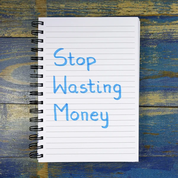 Stop Wasting Money text written in notebook on wooden background — Stockfoto