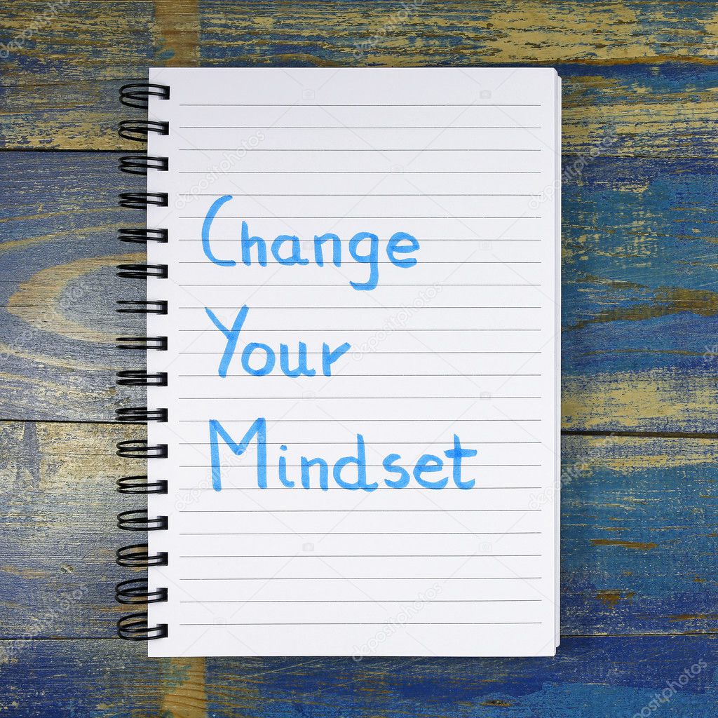 Change Your Mindset text written in notebook on wooden background