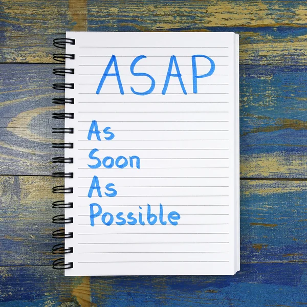 ASAP- As Soon As Possible text written in notebook on wooden background — Stock Photo, Image