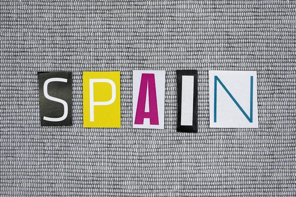 Spain word cut from newspaper — Stock Photo, Image