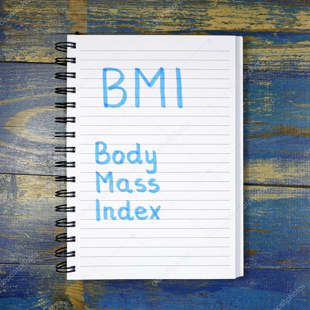 BMI- Body Mass Index acronym written in notebook on wooden background
