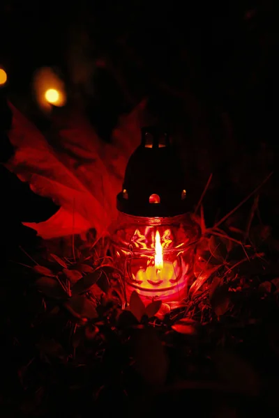 Burning candle at the cemetery on All Saints' Day — Stock Photo, Image