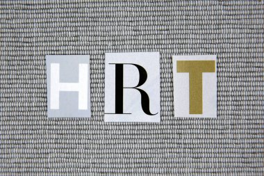 HRT (Hormone Replacement Therapy) acronym on grey background clipart