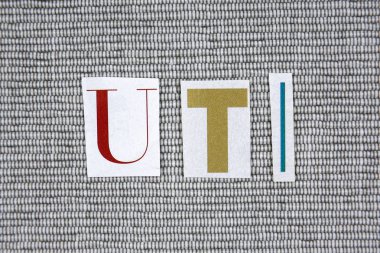 UTI (Urinary Tract Infection) acronym on grey background clipart