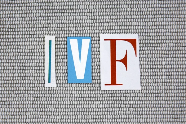 IVF (In Vitro Fertilization) acronym on grey background — Stock Photo, Image