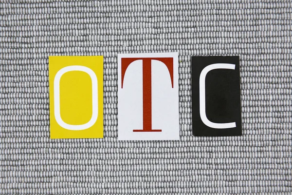 OTC (Over The Counter) acronym on grey background — Stock Photo, Image