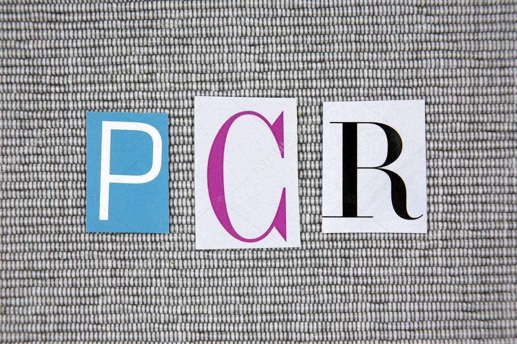 PCR (Polymerase Chain Reaction) acronym on grey background