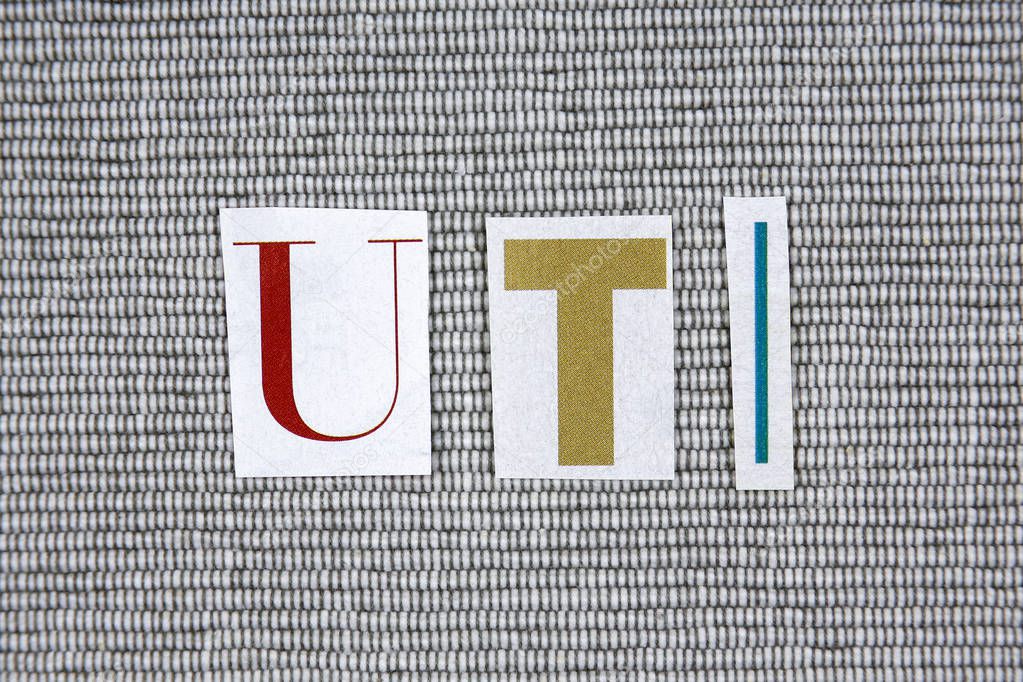 UTI (Urinary Tract Infection) acronym on grey background