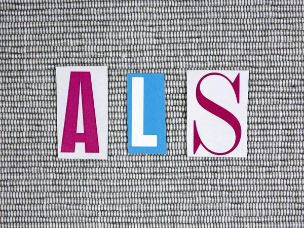 ALS (Esclerose Lateral Amiotrófica) acrônimo no fundo cinza — Fotografia de Stock