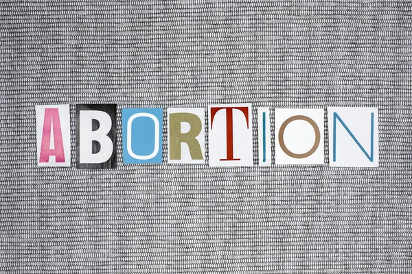 Palabra aborto sobre fondo gris — Foto de Stock