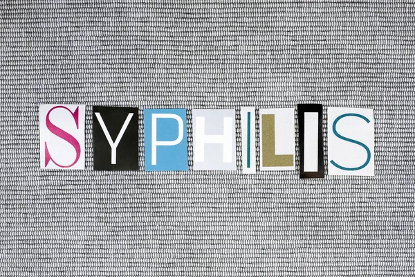 Sifilide parola su sfondo grigio, concetto medico — Foto Stock