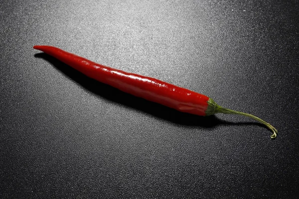 Red chili pepper on black background — Stock Photo, Image
