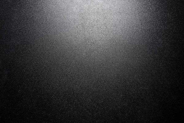 Black sparkling background with spotlight — Stock Photo, Image