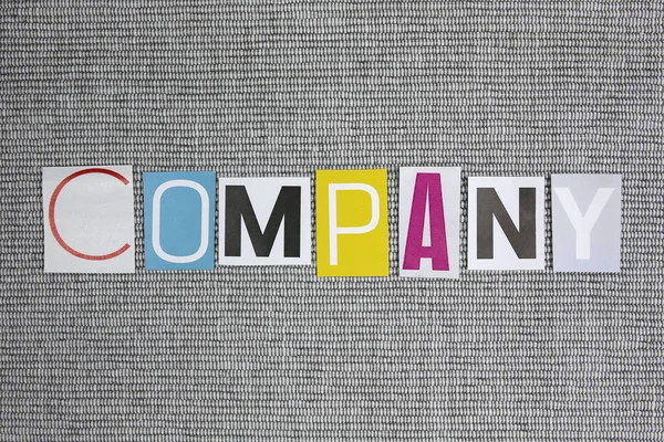 Parola dell'azienda su sfondo grigio — Foto Stock