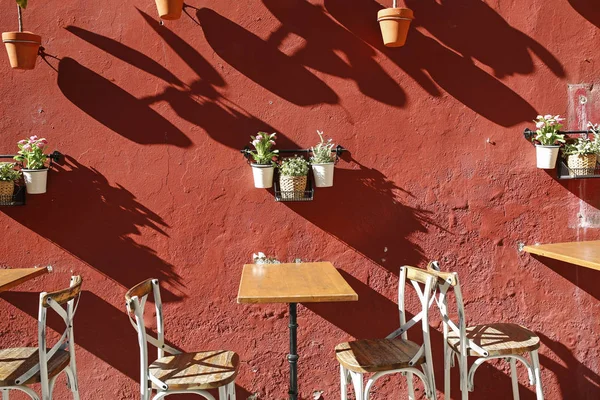 Stühle, Tische und Vintage-Wand mit Blumen dekoriert — Stockfoto