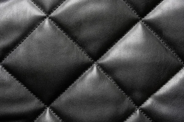 Black quilted leather background — Stock Photo, Image