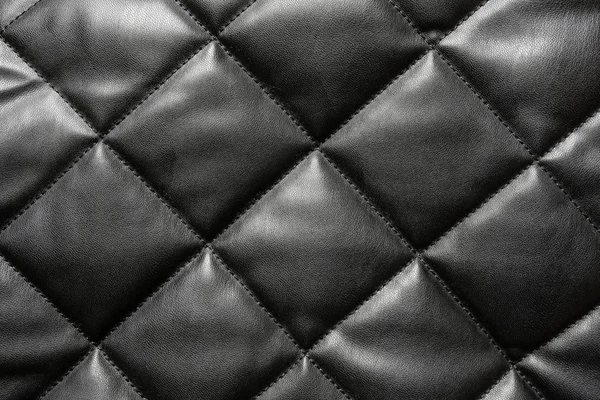 Black quilted leather background — Stock Photo, Image