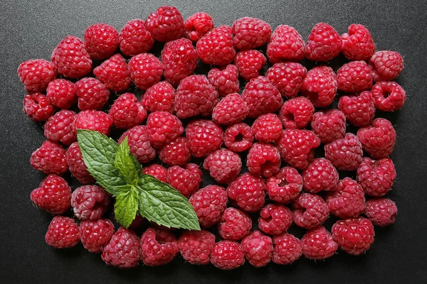 Fresh raspberries with mint leaf on black background — Stock Photo, Image