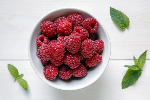 Raspberries in a bowl on white background — Stock Photo, Image