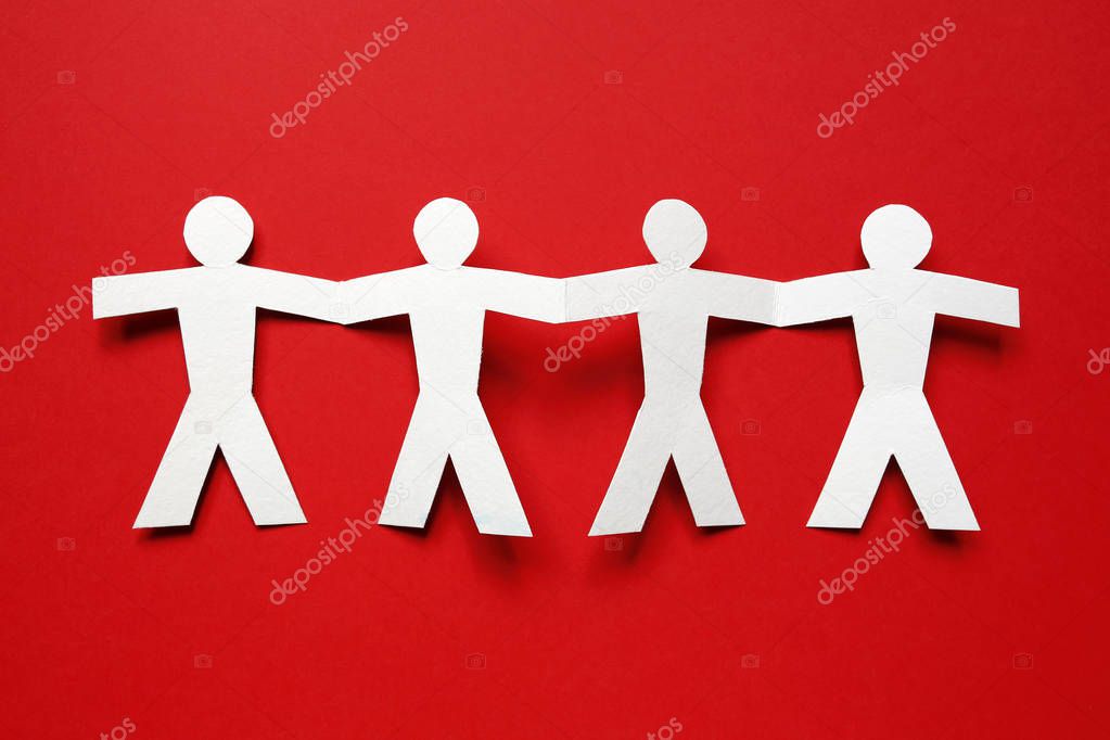 chain of paper people on red background
