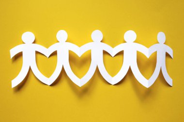 beyaz kağıt insanlar sarı arka plan, ekip çalışması kavramı üzerinde