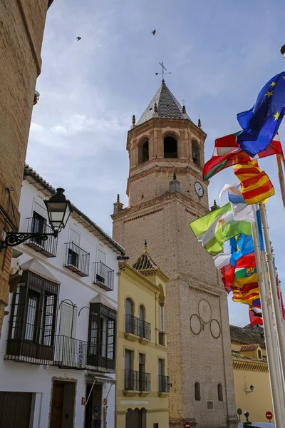 VELEZ-MALAGA, COSTA DEL SOL, SPAIN, MARCH 6, 2017: fluttering flags and Church of San Juan Bautista in Velez-Malaga.VELEZ-MALAGA, COSTA DEL SOL, SPAIN, MARCH 6, 2017: fluttering fl — Stock Photo, Image