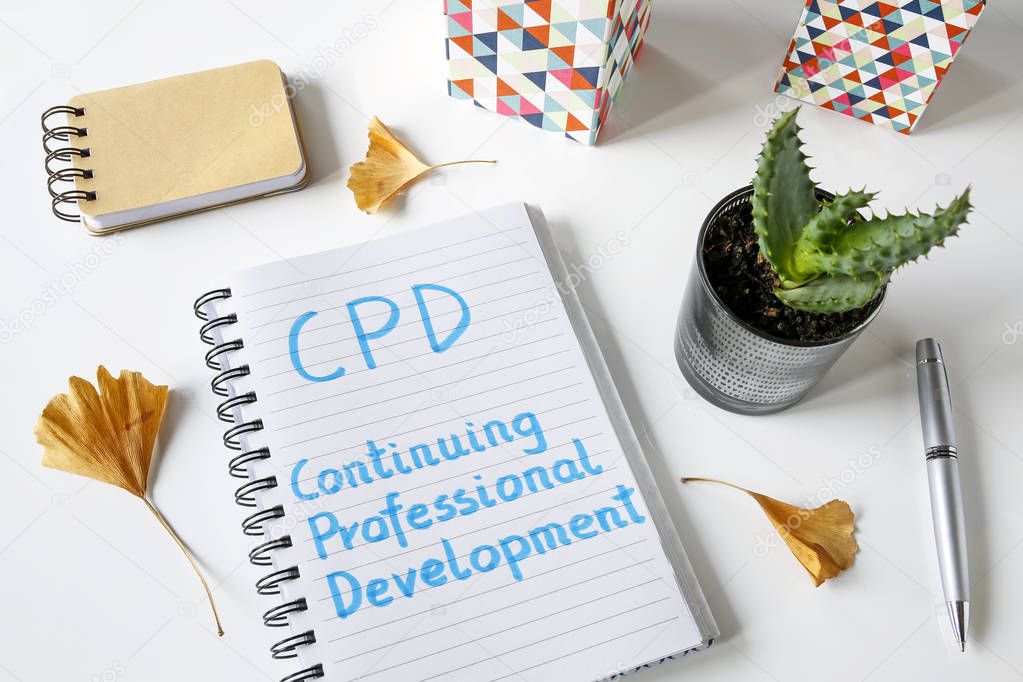 CPD Continuing Professional Development written in notebook on white table