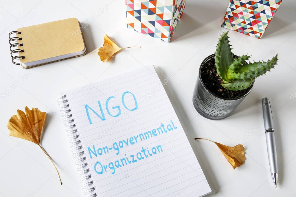 NGO Non-Governmental Organization written in notebook on white table