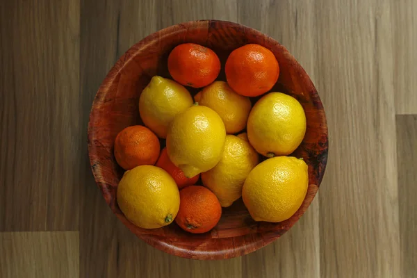 Citruses in a wooden bowl — Stock Photo, Image