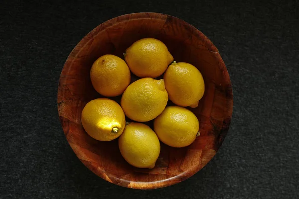 Citruses in a wooden bowl — Stock Photo, Image