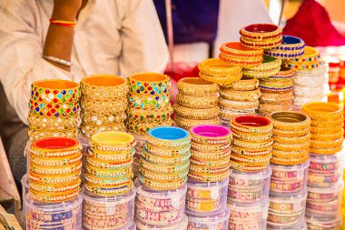 Hindistan 'ın Rajasthan, Rajasthan pazarındaki yerel bir dükkanda sergilenen Hindistan renkli bilezikler ve altın bilezikler veya kolluklar.