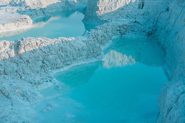 white marble dumping yard water body with blue reflection lime stone and background.