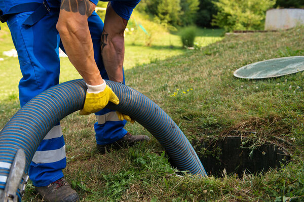 Emptying household septic tank. Cleaning sludge from septic system.