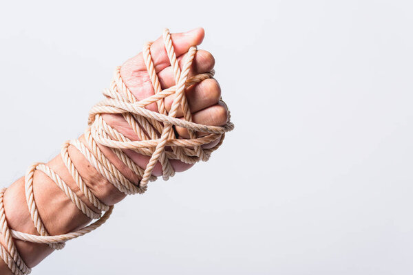 Rope on fist hand on white background, Human rights day concept
