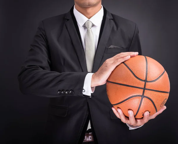 Joven empresario sosteniendo pelota de baloncesto — Foto de Stock