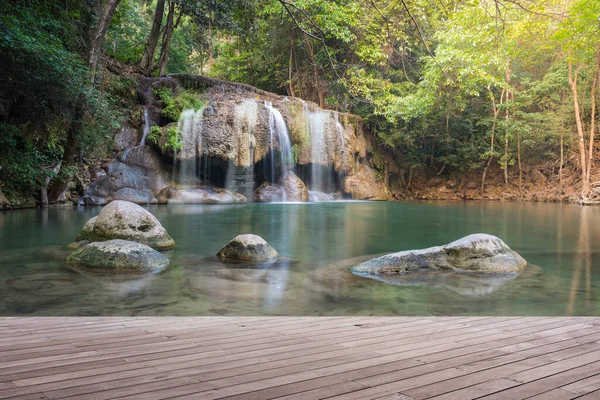 Wooden plank and background with Waterfall — Stock Photo, Image