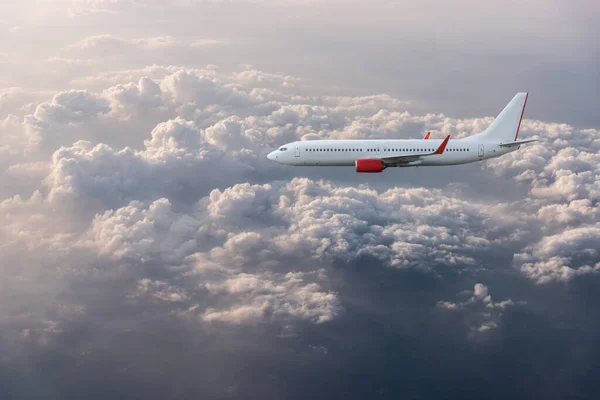 Airplane in the cloudy sky — Stock Photo, Image