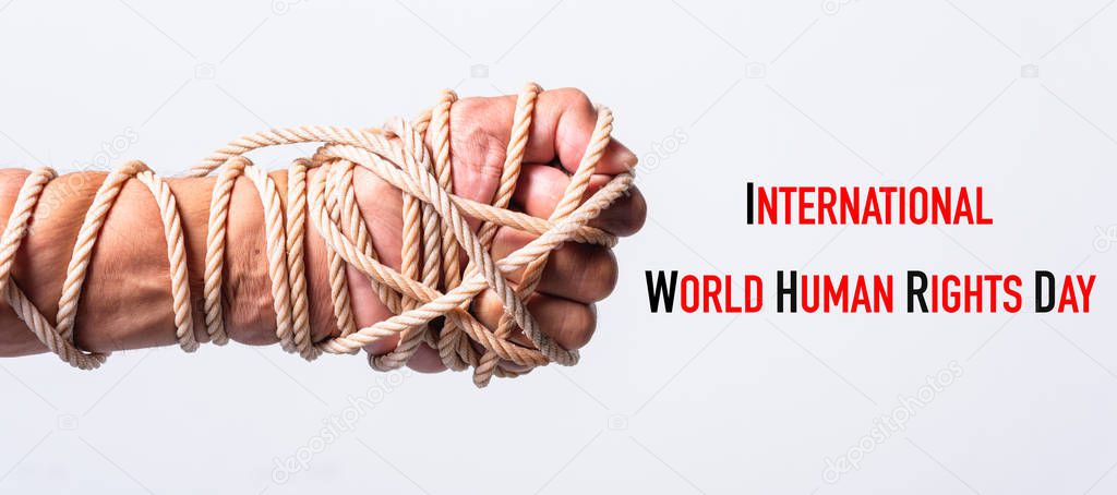 Rope on fist hand with international World HUMAN RIGHTS DAY text on white background, Human rights day concept