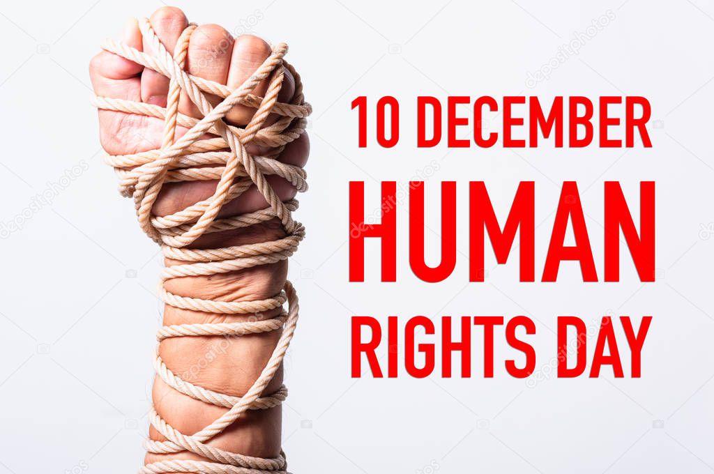 Rope on fist hand with 10 december HUMAN RIGHTS DAY text on white background, Human rights day concept