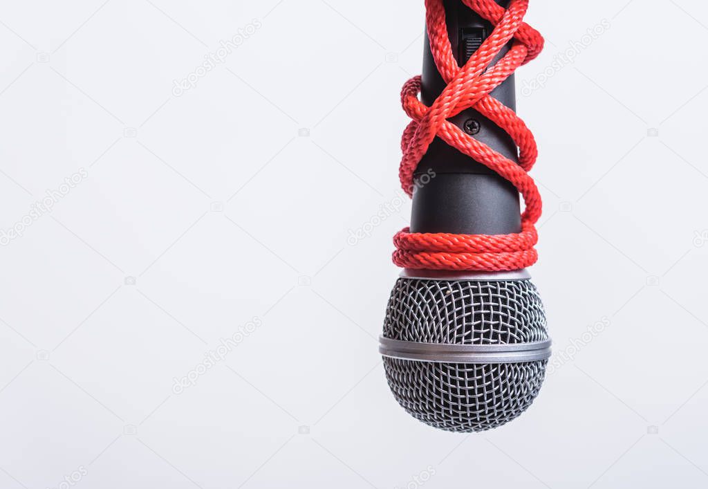 Rope on microphone with copy space on white background, Human rights day concept