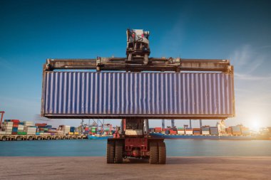 Forklift handling container box loading at port cargo at sunset clipart