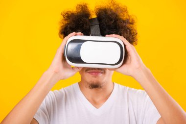 Asian handsome man with curly hair he using virtual reality head