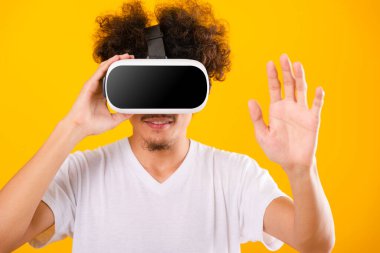 Asian handsome man with curly hair he using virtual reality head